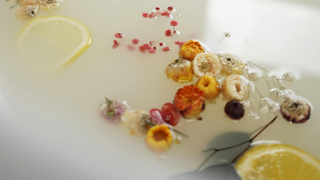 Flowers and lemon slices soaking in a milk bath